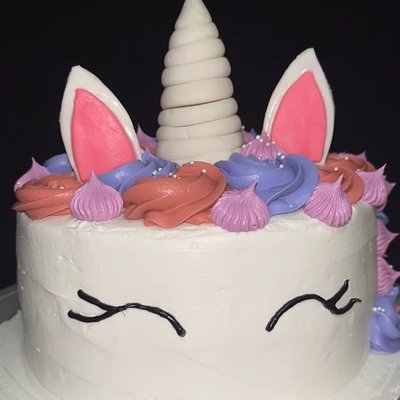 Unicorn cake with a white horn and pastel buttercream mane